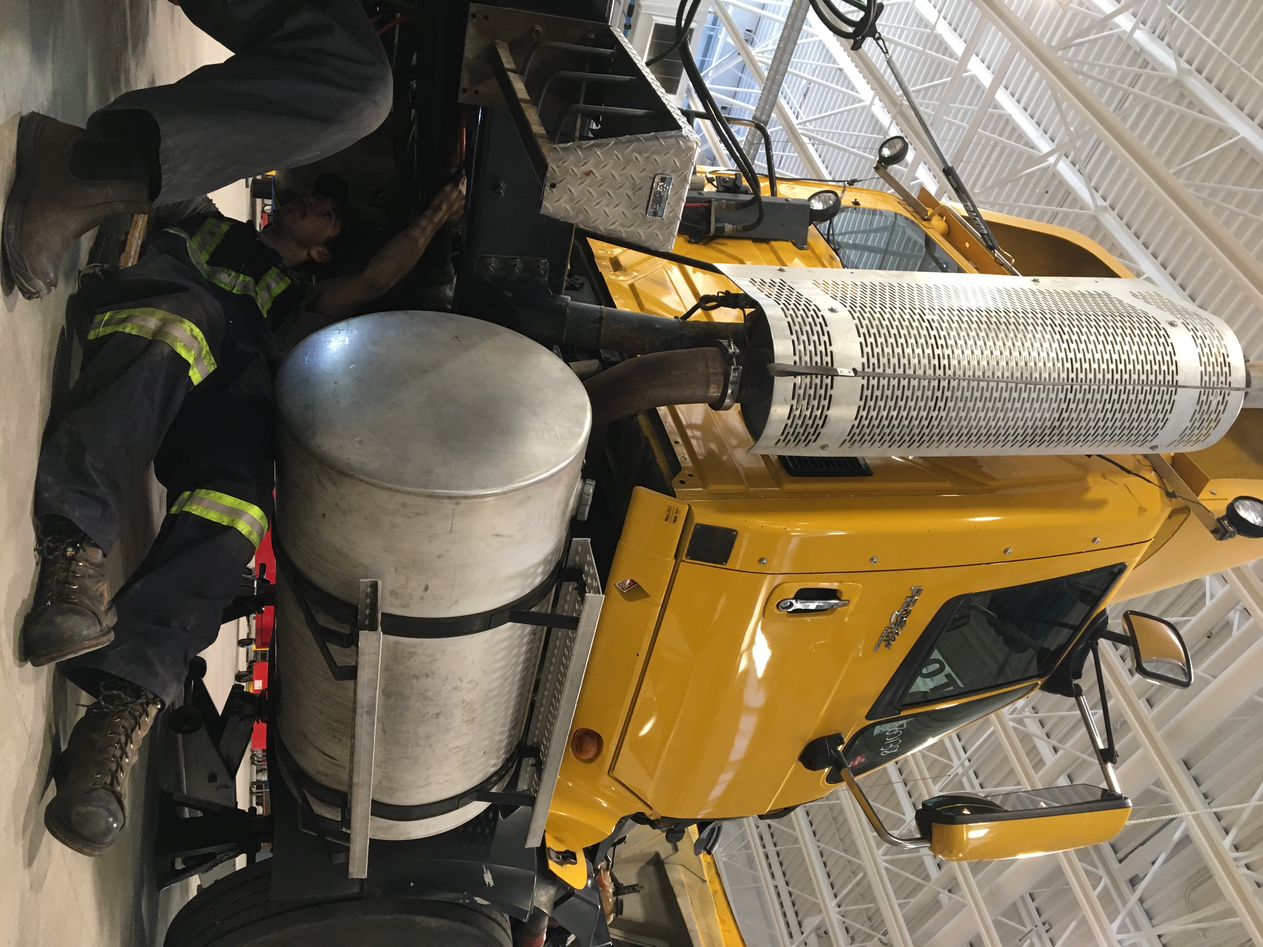 Mechanic under a heavy duty commercial semi-truck